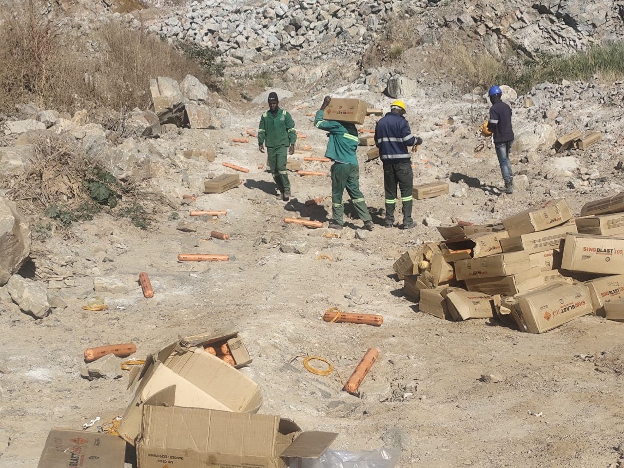 Crew loading and preparing a controlled quarry blast